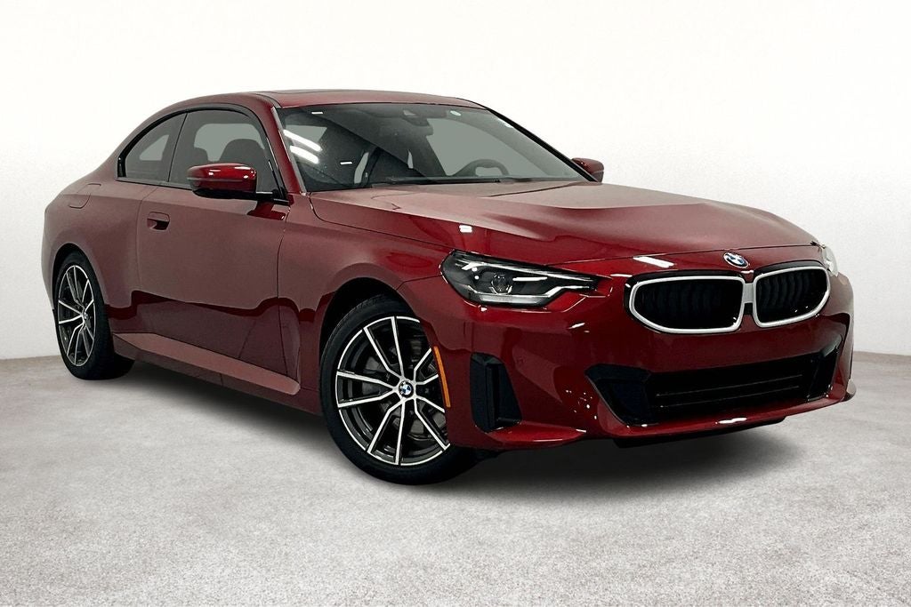 2025 BMW 2 Series 230i in Vegas Red Metallic — front three-quarter view