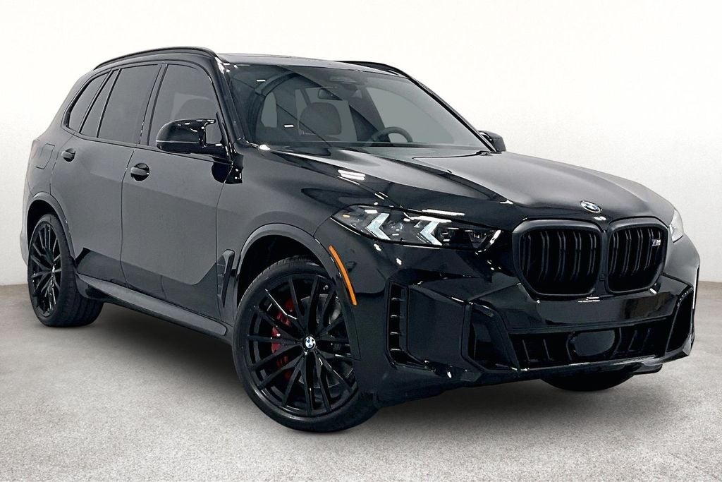 2026 BMW X5 M60i in Black Sapphire Metallic — front three-quarter view