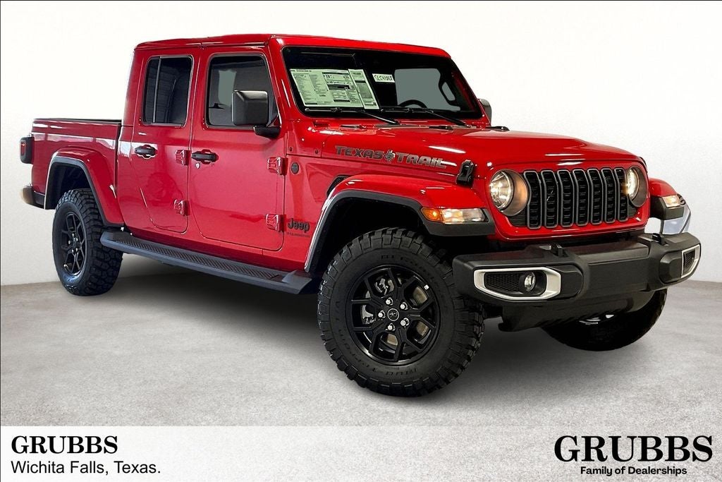 2025 Jeep Gladiator GLADIATOR TEXAS TRAIL 4X4 in Firecracker Red Clear-Coat Exterior Paint — front three-quarter view